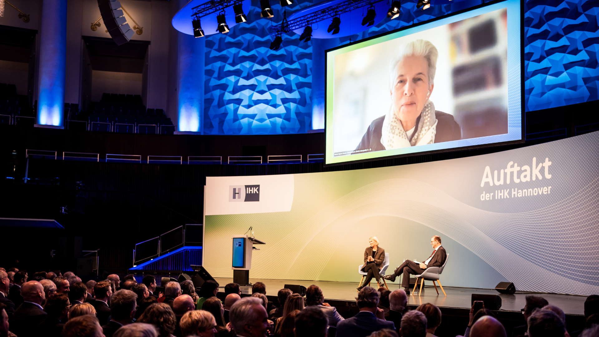 Marie-Agnes Strack-Zimmermann, zugeschaltet beim IHK Auftakt 2026 in Hannover. Auf der Bühne: USA-Expertin Cathryn Clüver-Ashbrook und Moderator Martin Brüning / Foto: Stefan Finger, IHK Hannover